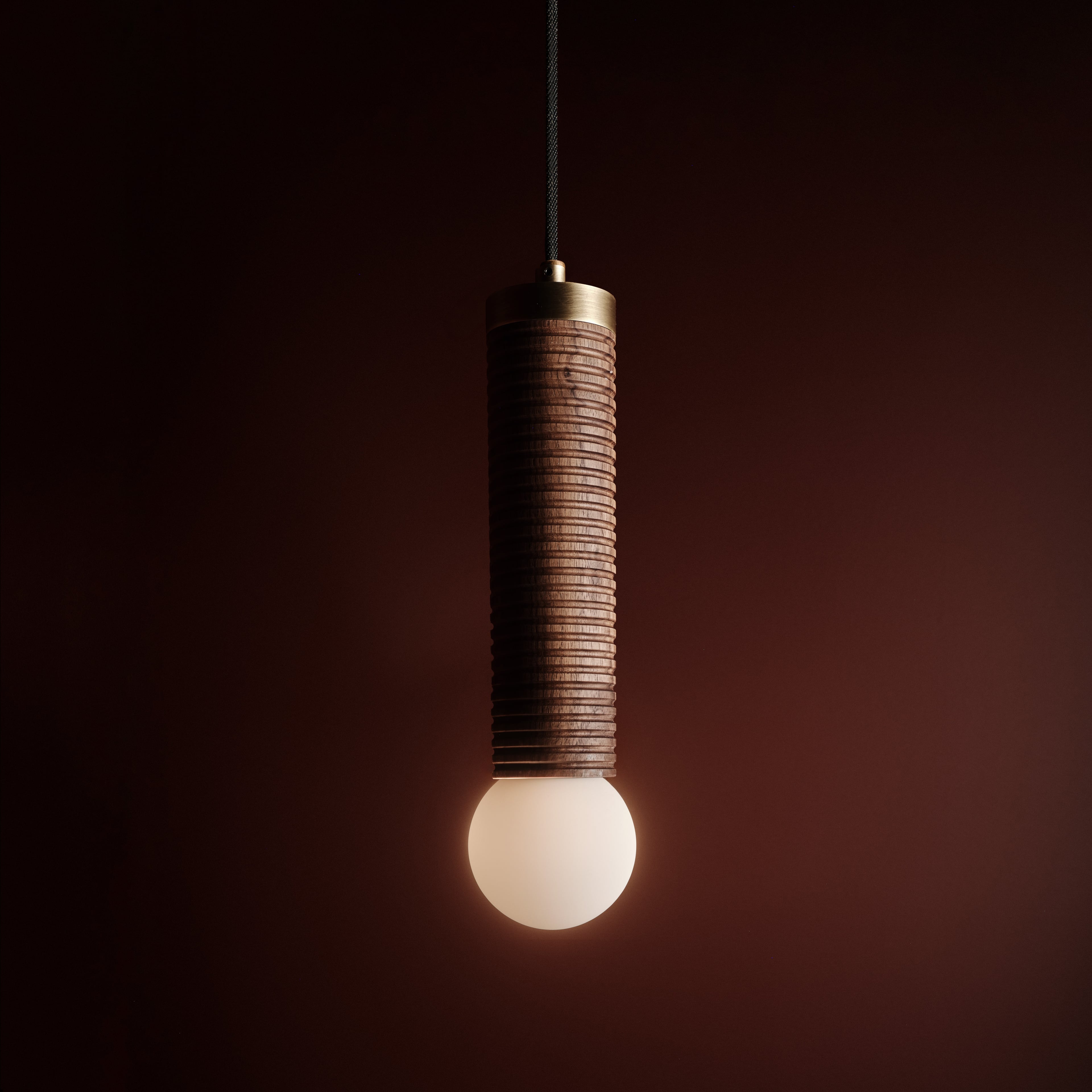 Axis Ceiling Pendant in walnut and aged brass, lit, Studio Baldo