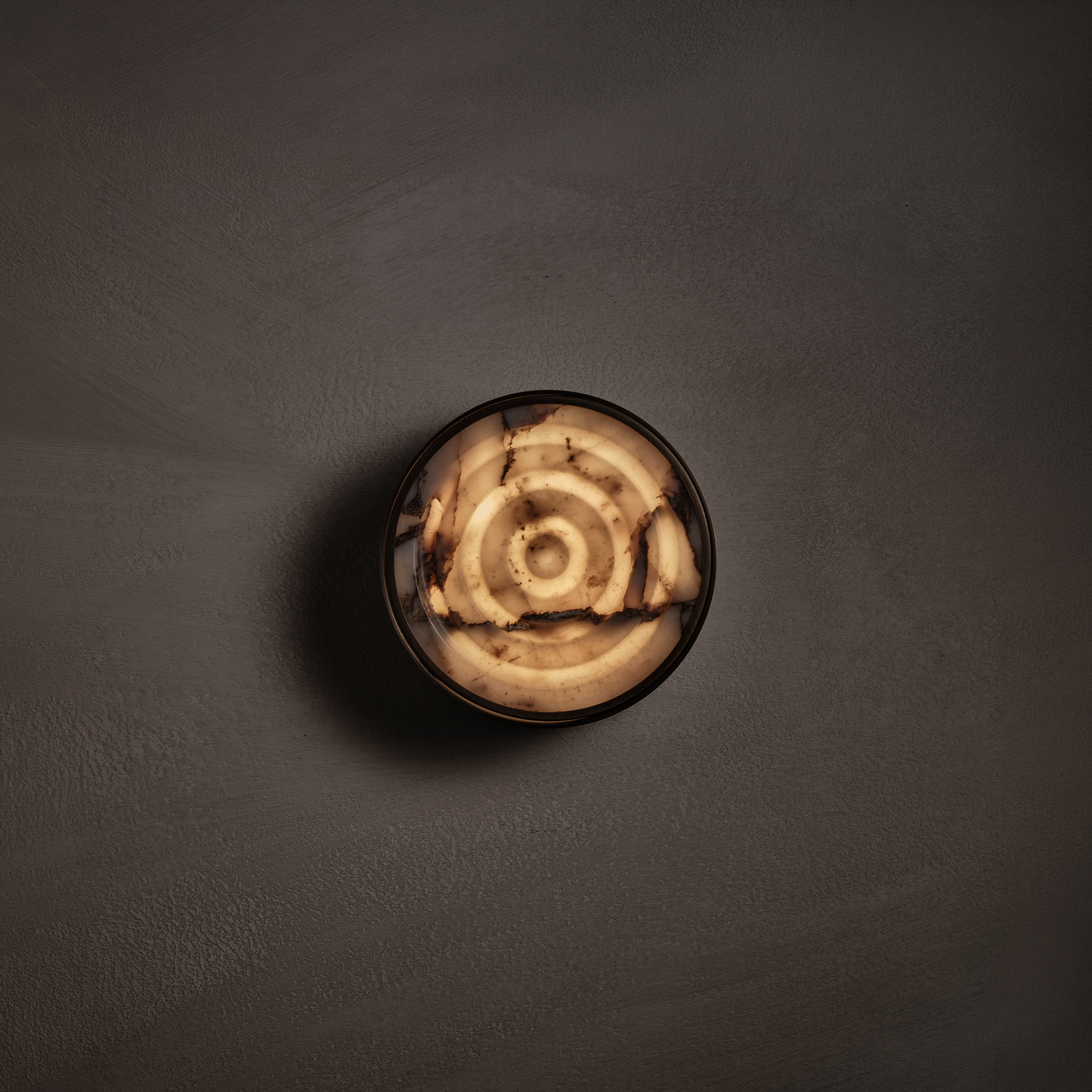Ciclo Wall Sconce in Calacatta Viola and brown wax polished, lit, Studio Baldo