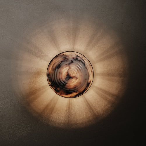 Contour Wall Sconce in Calacatta Viola and brown wax polished, lit, Studio Baldo