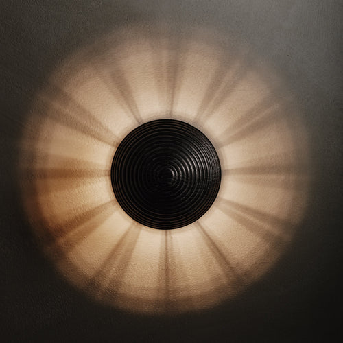 Contour Wall Sconce in ebonized and aged brass, lit, Studio Baldo